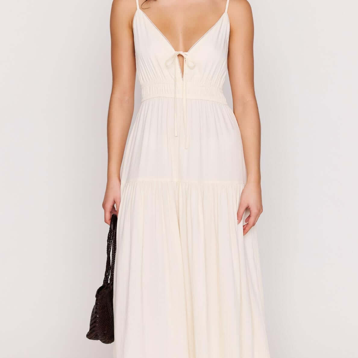 Cream Tie Front Tiered Maxi Dress worn by model, showcasing a flattering V-neckline and stylish tie-front detail.