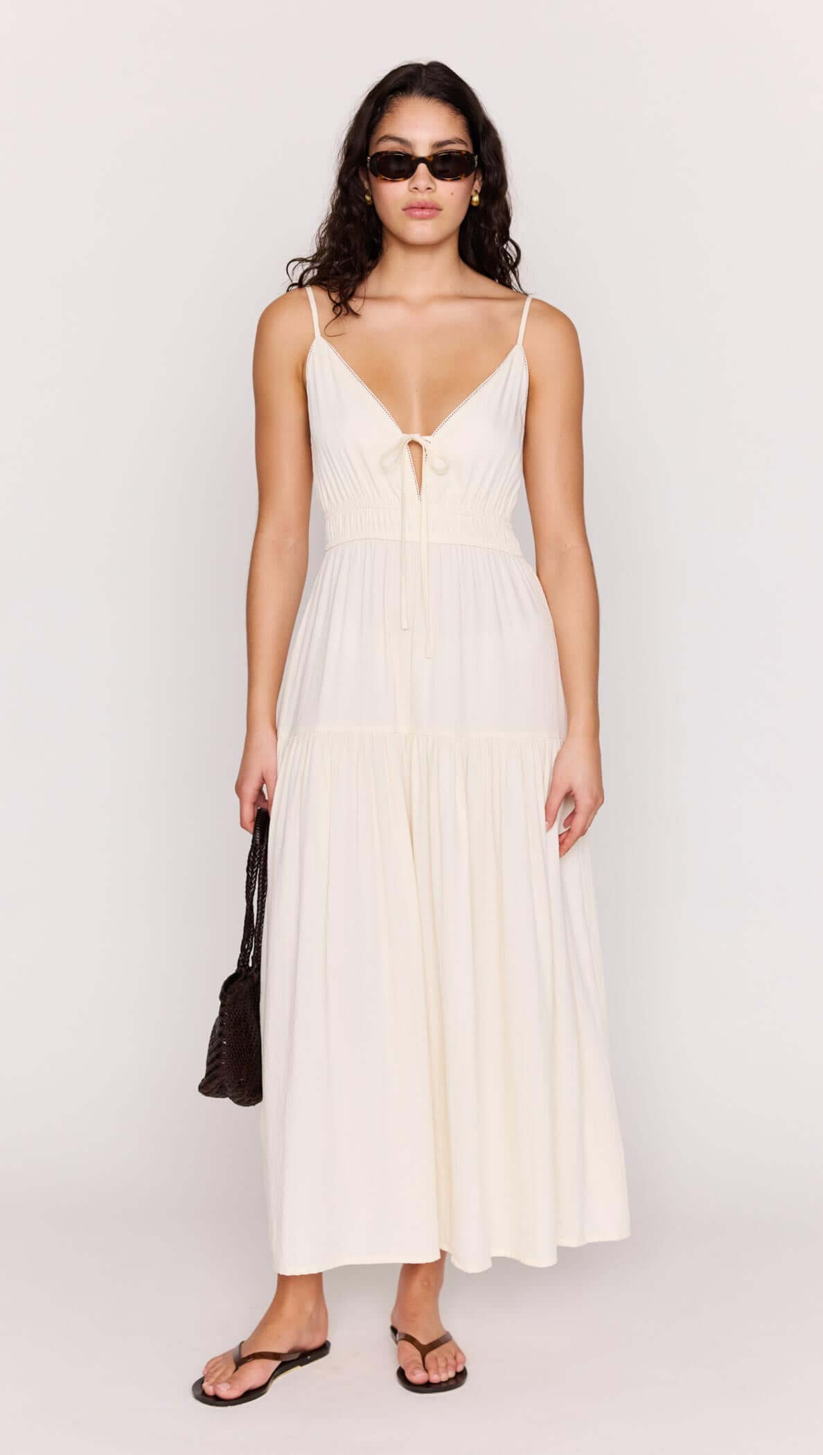 Cream Tie Front Tiered Maxi Dress worn by model, showcasing a flattering V-neckline and stylish tie-front detail.