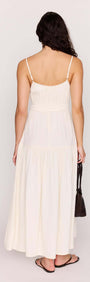 Back view of the Cream Tie Front Tiered Maxi Dress showcasing its flowing design and adjustable straps.