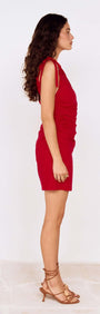 Side view of a model wearing a Deep Red Tie Shoulder Mini Dress showcasing its stylish design and flattering fit.