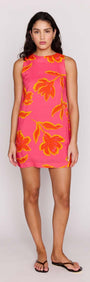 Model wearing ELODIE SHIFT MINI DRESS in bright pink with floral pattern for a stylish summer look.