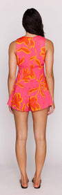 ELODIE SLEEVELESS PLAYSUIT showcasing a vibrant pink floral design, perfect for summer fun and stylish outings.