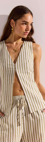 Model wearing Olive & White Stripe Cotton Blend Vest with deep V-neckline and relaxed fit, styled for warm weather.