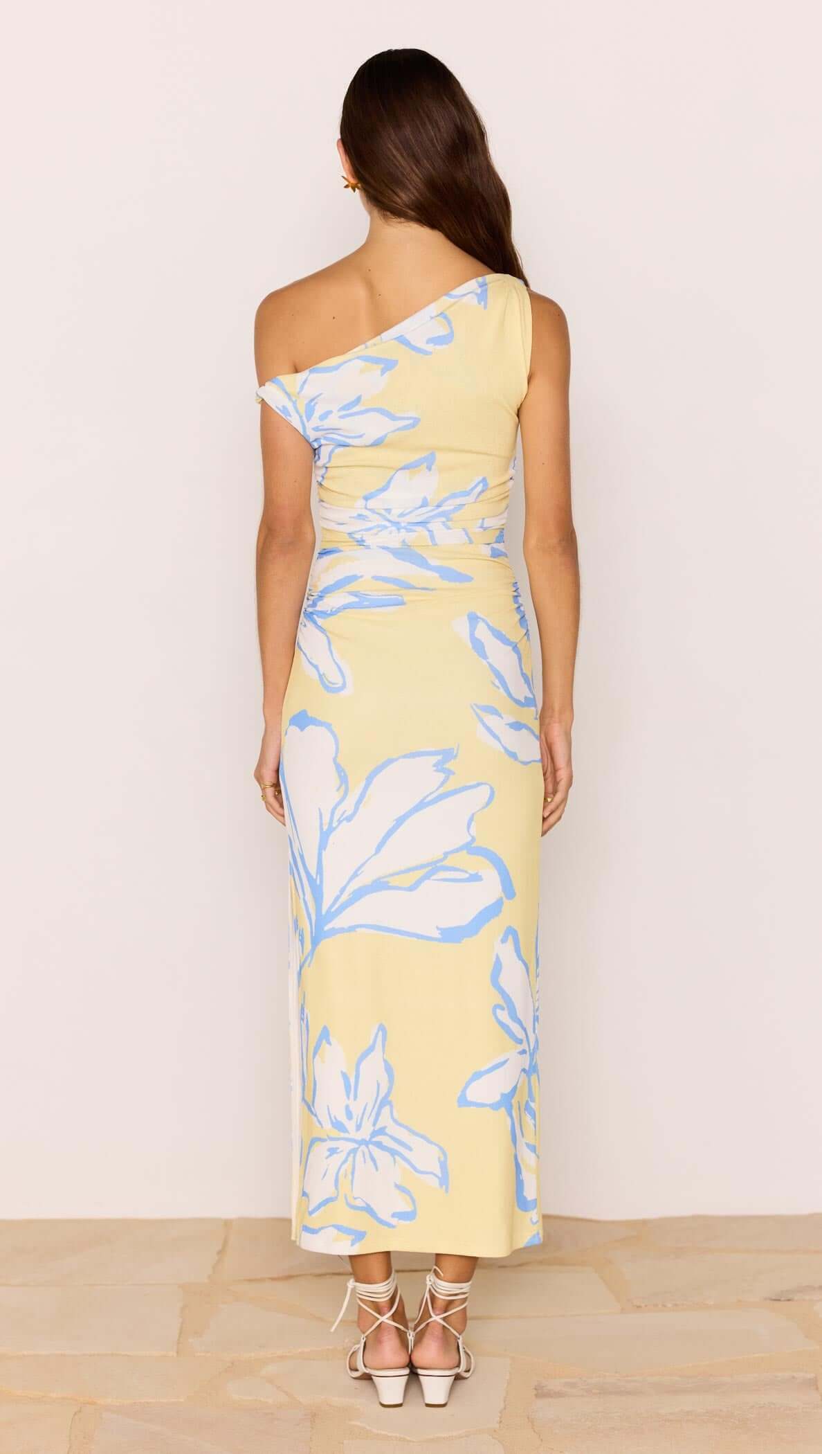 Back view of the Yellow & Blue Floral Asymmetric Mesh Maxi Dress highlighting the floral print and one-shoulder design.