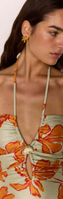 Green & Orange Floral Cut Out Swimsuit with Shell Embellishment on model, featuring keyhole cut-out and vibrant floral design.