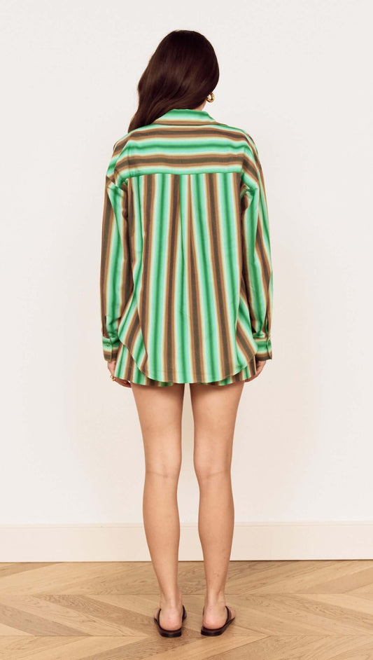 Back view of a model wearing the Green Stripe Cotton Oversized Shirt featuring a painterly stripe design.