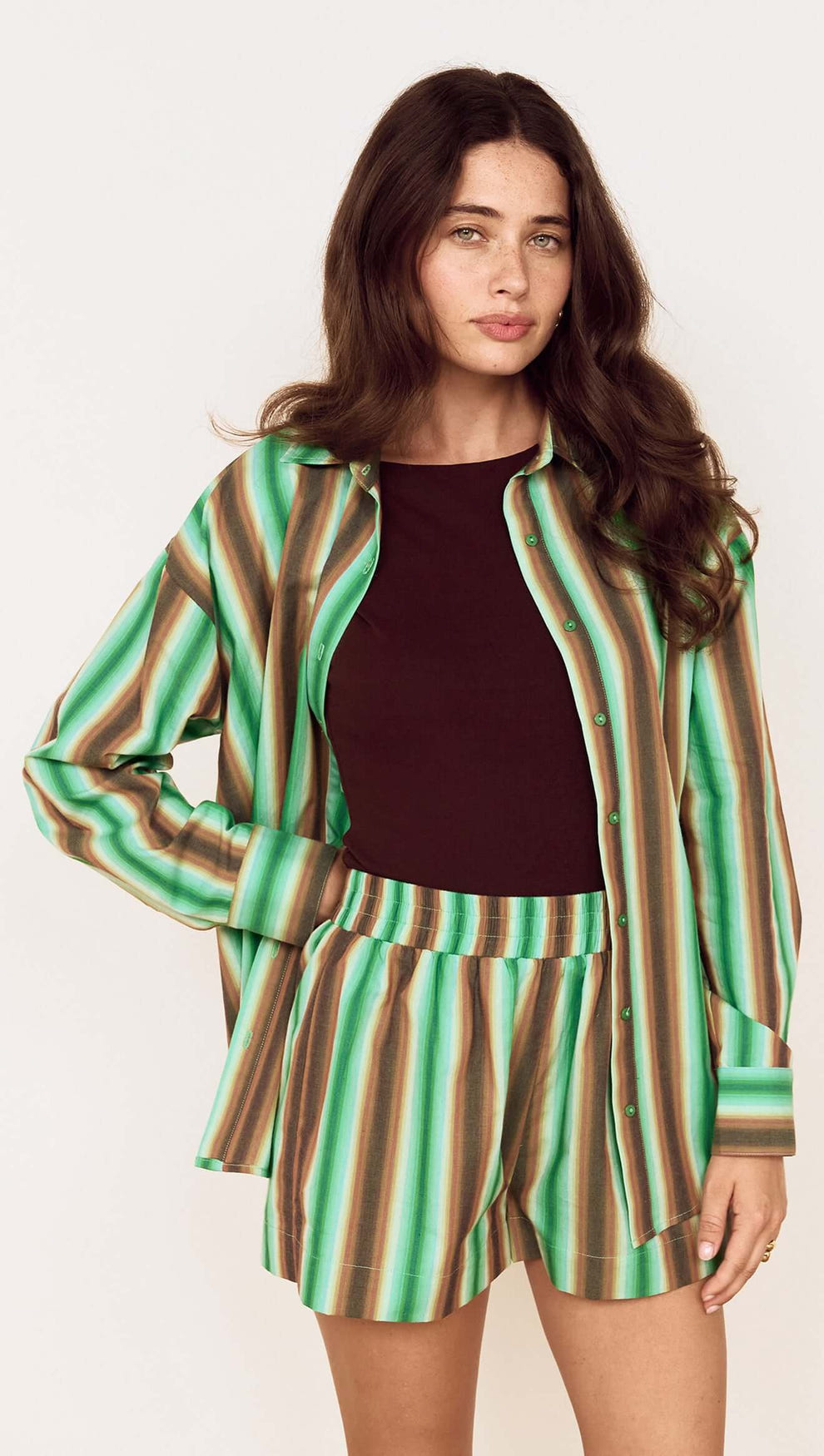 Model showcasing the Green Stripe Cotton Relaxed Short with matching shirt, perfect for summer styling.