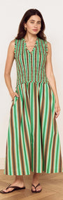 Model wearing the Green Stripe Cotton Shirred Midi Dress showcasing a vibrant stripe print and flattering fit.