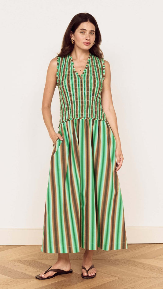 Model wearing the Green Stripe Cotton Shirred Midi Dress showcasing a vibrant stripe print and flattering fit.