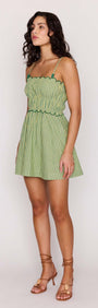 Green Striped Linen Blend Scallop Mini Dress styled on a model in a sunlit setting.