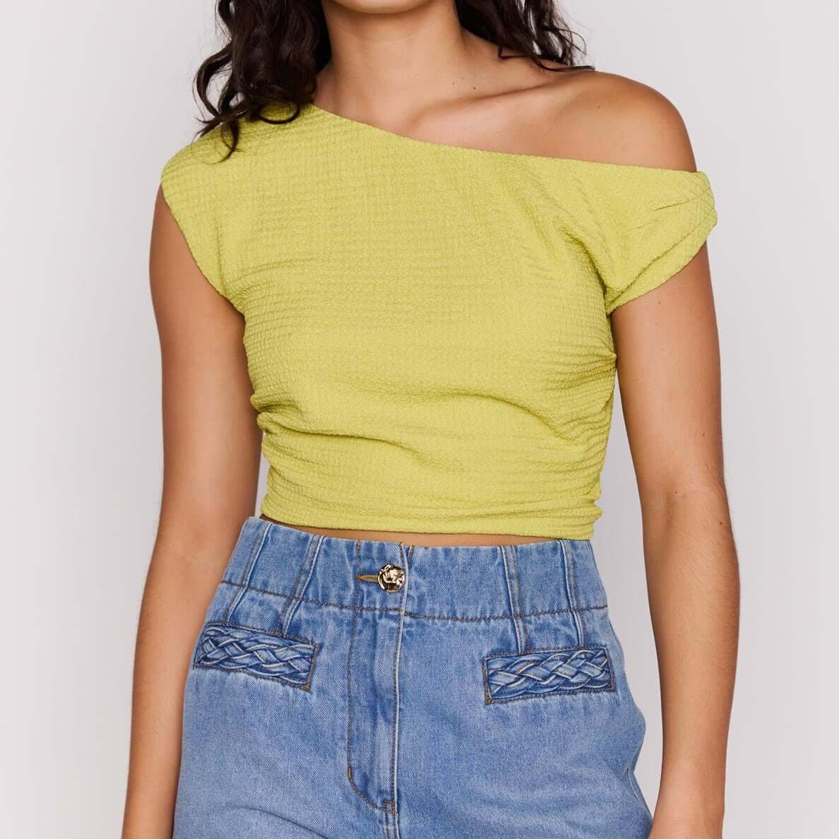 Model wearing High Waisted Cotton Blend Denim Short paired with a yellow cropped top and sunglasses.
