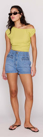 Model wearing High Waisted Cotton Blend Denim Short and a lime green top, showcasing a stylish summer outfit.