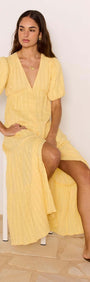 Relaxed Yellow Cotton Tiered Maxi Dress worn by a model, showcasing the V-neckline and tiered skirt design.