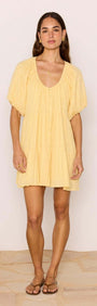 Relaxed Yellow Cotton Tiered Mini Dress worn by a model, showcasing its soft crinkle texture and feminine silhouette.