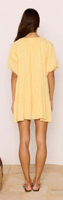Relaxed Yellow Cotton Tiered Mini Dress shown from the back, featuring a tiered design and voluminous sleeves.