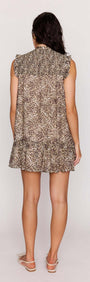 Back view of a model wearing the Leopard Smock Mini Dress with a tiered skirt and relaxed fit.