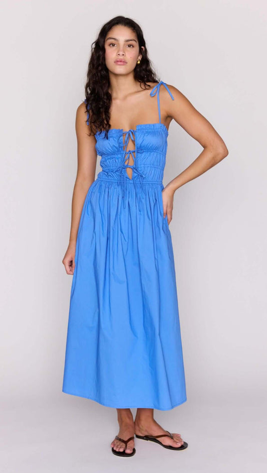Blue Cotton Tie Detail Midi Dress on a model, showcasing its flattering shirred bodice and adjustable front tie.