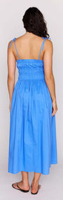 Back view of the Liana Blue Cotton Tie Detail Midi Dress showcasing the shirred bodice and playful design.