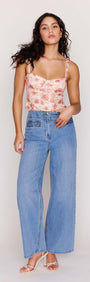 Model wearing Light Wash Straight Leg Denim Jeans with floral crop top and sandals.