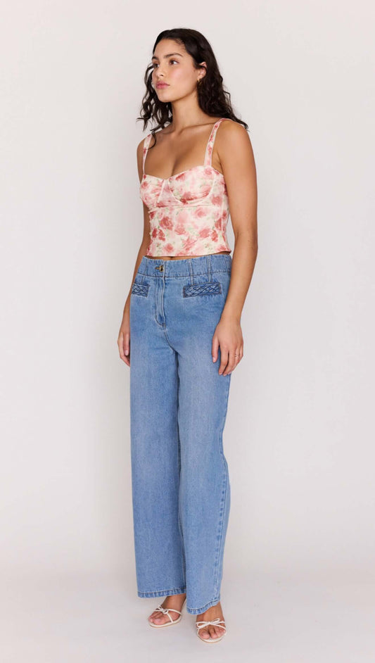 Model wearing Light Wash Straight Leg Denim Jeans with floral top, showcasing high-rise waist and straight-leg fit.