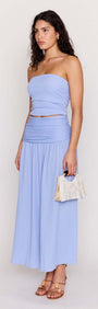 Model wearing Powder Blue Yoke Detail Maxi Skirt with matching top and handbag, showcasing summer fashion.