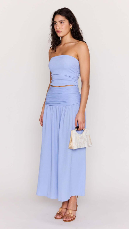 Model wearing Powder Blue Yoke Detail Maxi Skirt with matching top and handbag, showcasing summer fashion.