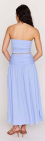 Back view of a woman wearing a Powder Blue Yoke Detail Maxi Skirt paired with a matching strapless top.