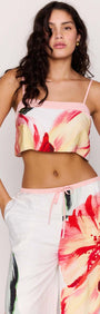 Model wearing a Macro Floral Print Cropped Cami with vibrant floral design, styled with matching lightweight pants.