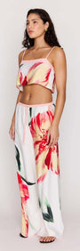 Model wearing a Macro Floral Print Cropped Cami with wide-legged pants featuring vibrant floral patterns.