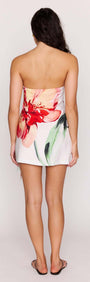 Model wearing a Macro Floral Print Strapless Mini Dress, showcasing the back view and vibrant floral design.