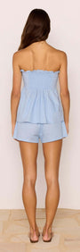 Back view of a model wearing the Cotton Linen Blend Blue Pintuck Top with matching shorts.