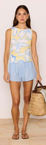 Model wearing Cotton Linen Blend Blue Relaxed Shorts with a floral top and carrying a straw bag.