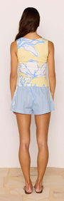 Model wearing Cotton Linen Blend Blue Relaxed Shorts with a floral top, showcasing the back view of the outfit.