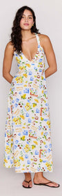 A model wearing the Mediterranean Print Halter Midi Dress featuring a V-neckline and cross-back detail.