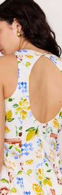 Girl wearing a Mediterranean Print Open Back Mini Dress showcasing the vibrant floral and citrus design.