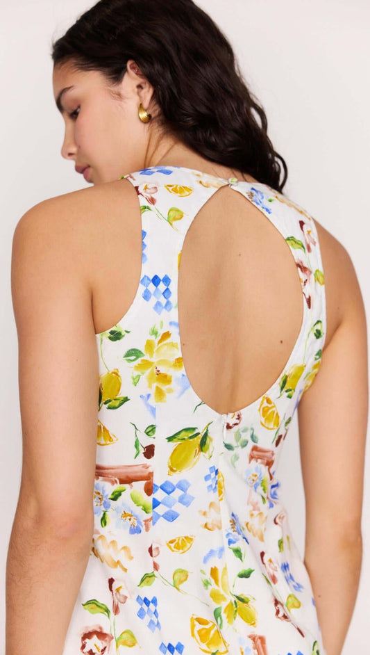 Girl wearing a Mediterranean Print Open Back Mini Dress showcasing the vibrant floral and citrus design.