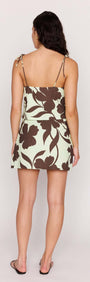 Back view of a woman wearing a Mint Chocolate Cotton Beaded Cami Top with chocolate floral print.