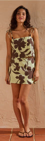 Model wearing a Mint Chocolate Cotton Floral Mini Skirt with a chocolate floral print, showcasing a modern mini silhouette.