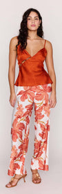 Model wearing Orange Bead Detail Satin Cami paired with floral pants, showcasing elegance and style.
