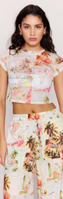 Model wearing a Palm Print Cropped Mesh Tee with vibrant vintage postcard design and cropped fit.