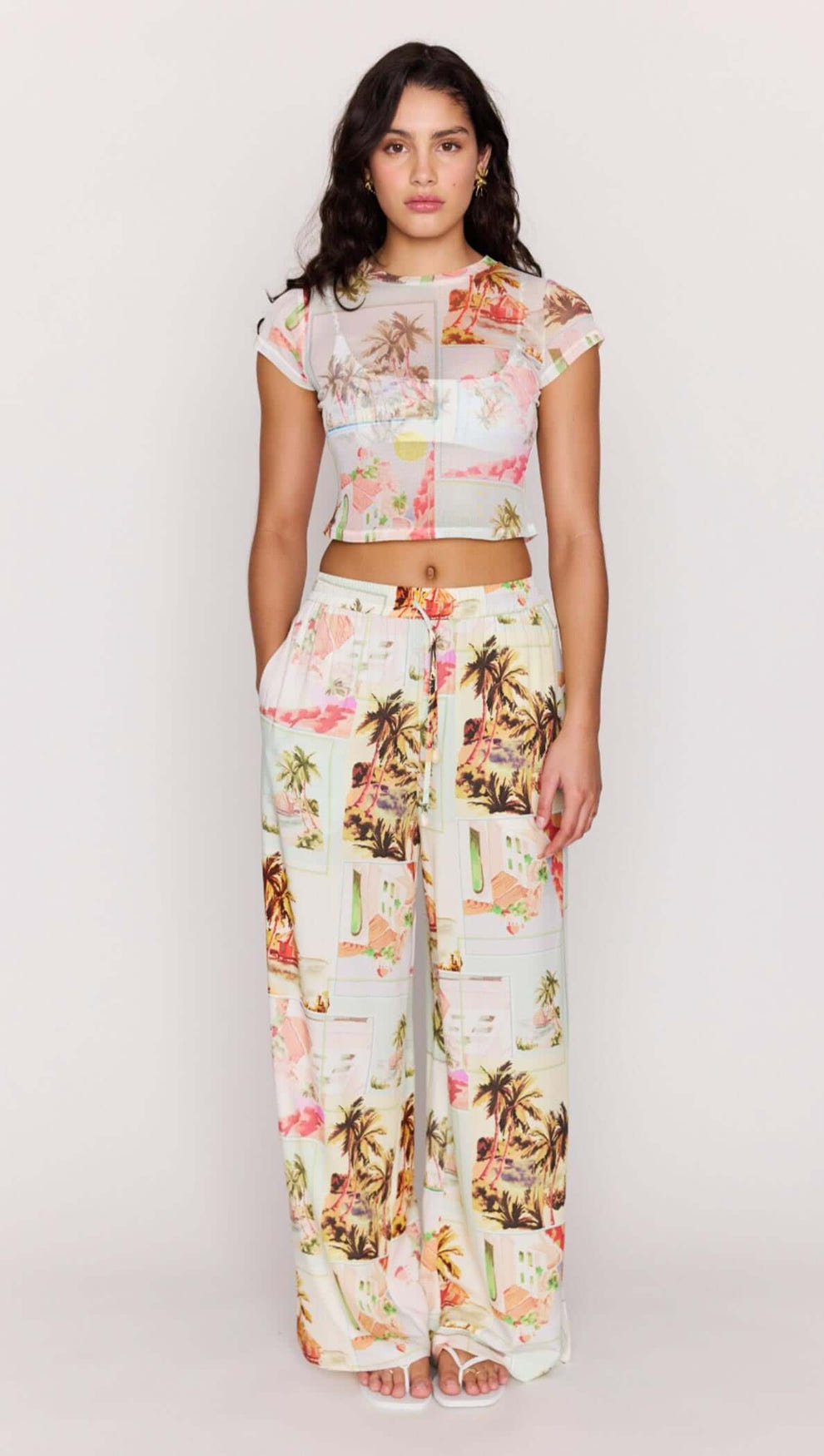 Model wearing Palm Print Cropped Mesh Tee with wide-leg pants featuring vintage postcard print.