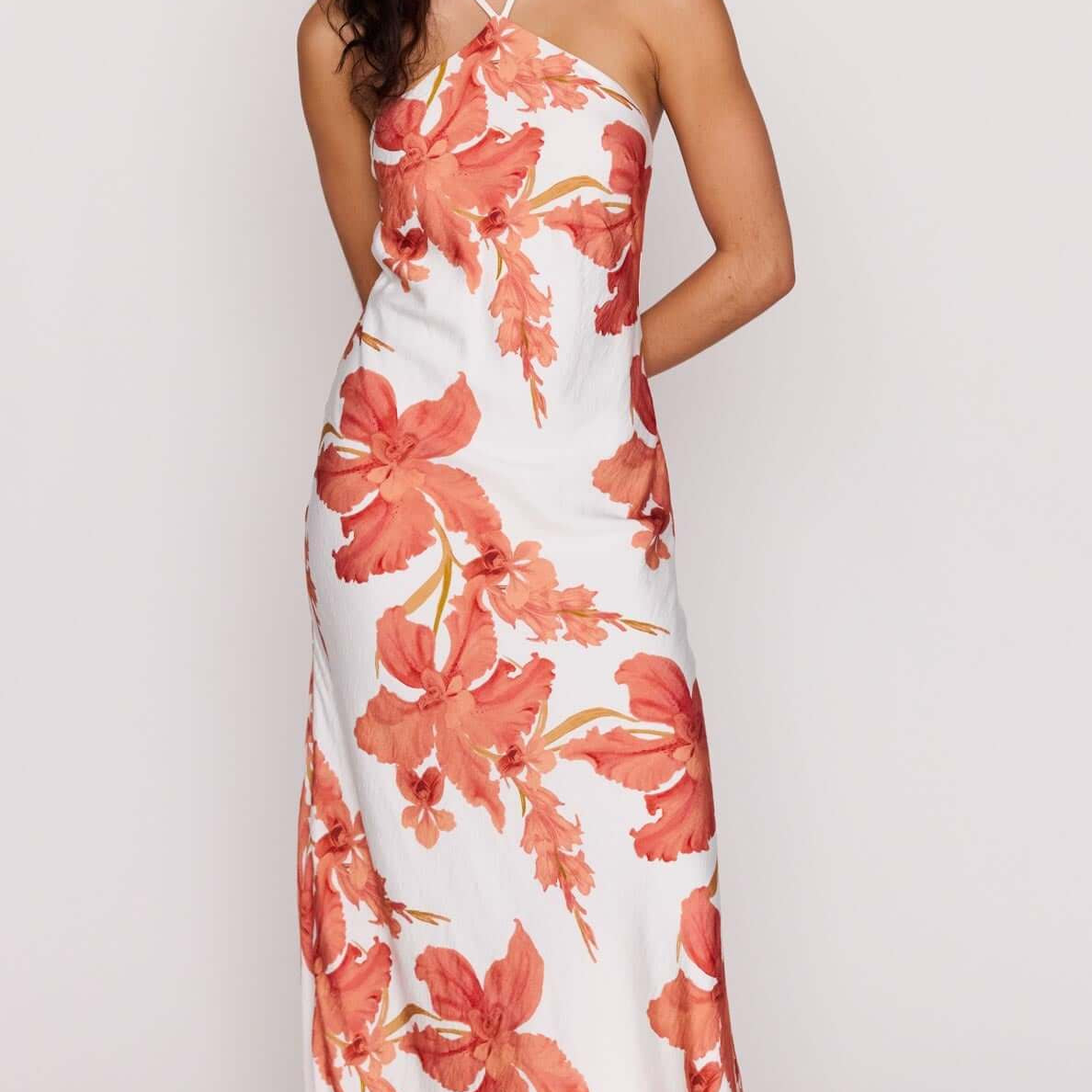 Peach Hibiscus Halter Midi Dress featuring a floral print, halter neckline, and flowing silhouette.