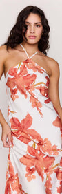 Model wearing a Peach Hibiscus Halter Midi Dress with a vibrant floral print, showcasing its elegant design and flattering fit.