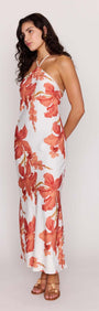Model wearing the Peach Hibiscus Halter Midi Dress with floral print and halter neckline