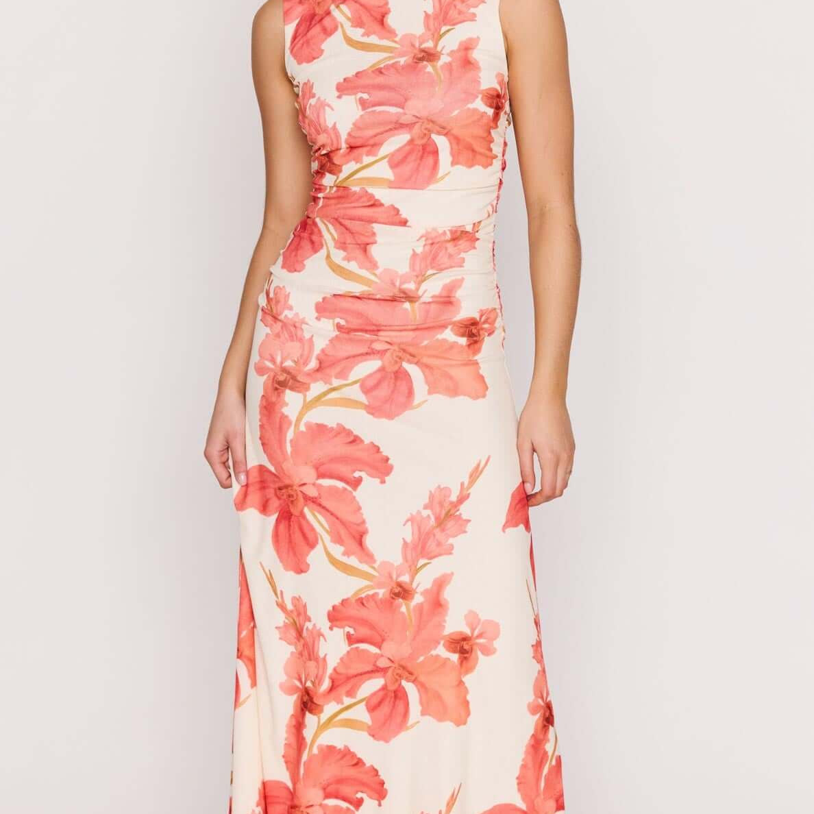 Model wearing the Peach Hibiscus Mesh Midi Dress with vibrant floral print, showcasing its flattering silhouette.