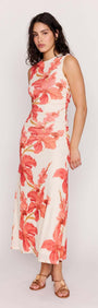 Model wearing the Isla Peach Hibiscus Mesh Midi Dress featuring a bold peach floral print and a flattering fit.