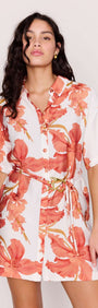 Model showcasing the Peach Hibiscus Mini Shirt Dress with vibrant floral print and detachable waist tie.