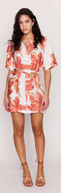Model wearing the Peach Hibiscus Mini Shirt Dress with a vibrant floral print and a relaxed silhouette.