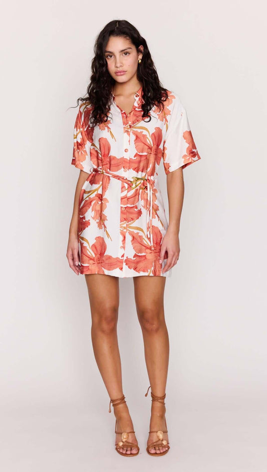 Model wearing the Peach Hibiscus Mini Shirt Dress with a vibrant floral print and a relaxed silhouette.