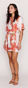 Model wearing a Peach Hibiscus Mini Shirt Dress with a relaxed silhouette and floral print.